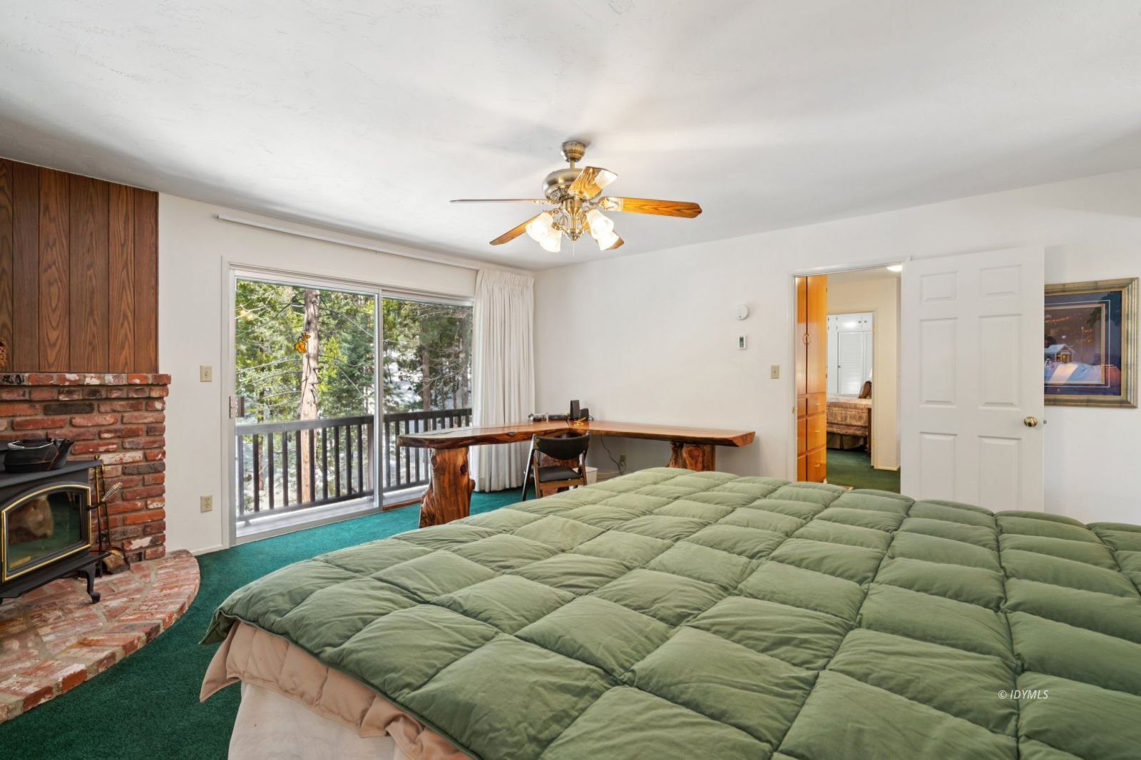 24490 Upper Rim Rock Road Idyllwild, CA 92549 - Photo 25 of 41 a bedroom with a bed chandelier and a window