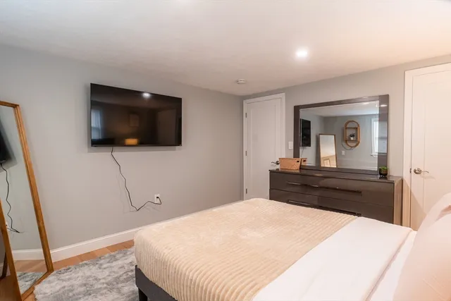 a bedroom with a bed and a flat screen tv