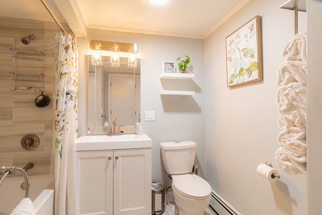 33 Bristow Street, Unit 2 Saugus, MA 01906 - Photo 15 of 21 a bathroom with a sink mirror vanity and toilet