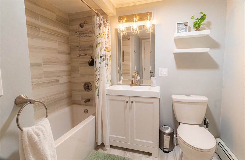 33 Bristow Street, Unit 2 Saugus, MA 01906 - Photo 17 of 21 a bathroom with a toilet sink and shower