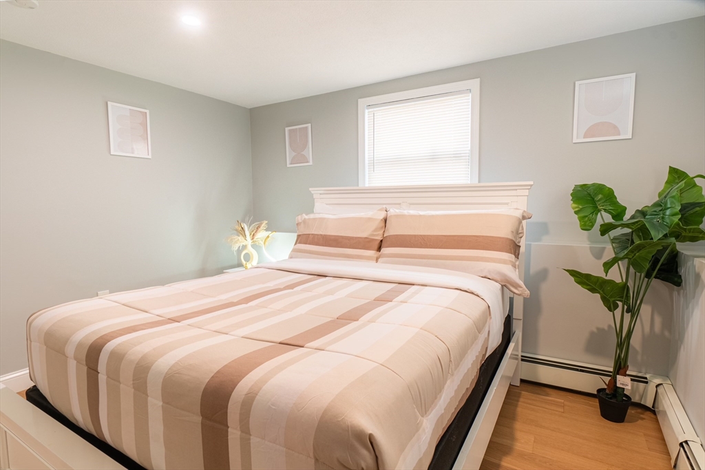 33 Bristow Street, Unit 2 Saugus, MA 01906 - Photo 19 of 21 a bedroom with a bed potted plant and a window