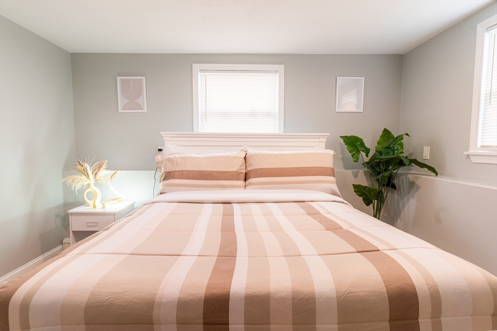 33 Bristow Street, Unit 2 Saugus, MA 01906 - Photo 20 of 21 a bedroom with a bed and a potted plant