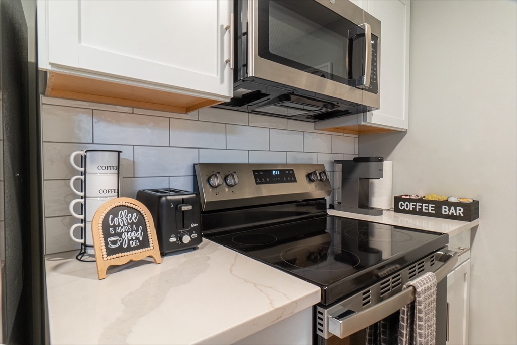 33 Bristow Street, Unit 2 Saugus, MA 01906 - Photo 3 of 21 a kitchen with a stove and a microwave