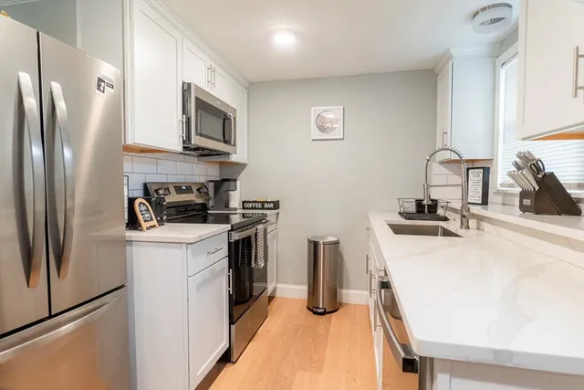 a kitchen with stainless steel appliances a refrigerator stove and sink