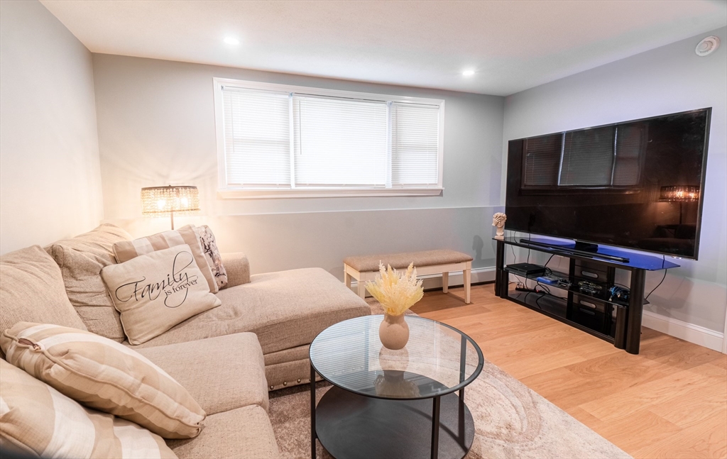 33 Bristow Street, Unit 2 Saugus, MA 01906 - Photo 7 of 21 a living room with furniture and a flat screen tv