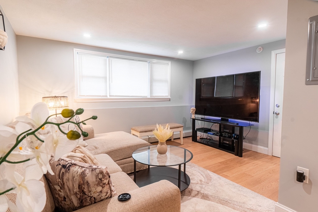 33 Bristow Street, Unit 2 Saugus, MA 01906 - Photo 9 of 21 a living room with furniture and a flat screen tv