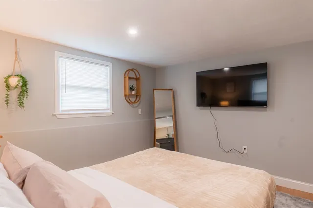 a bedroom with a bed and a flat screen tv