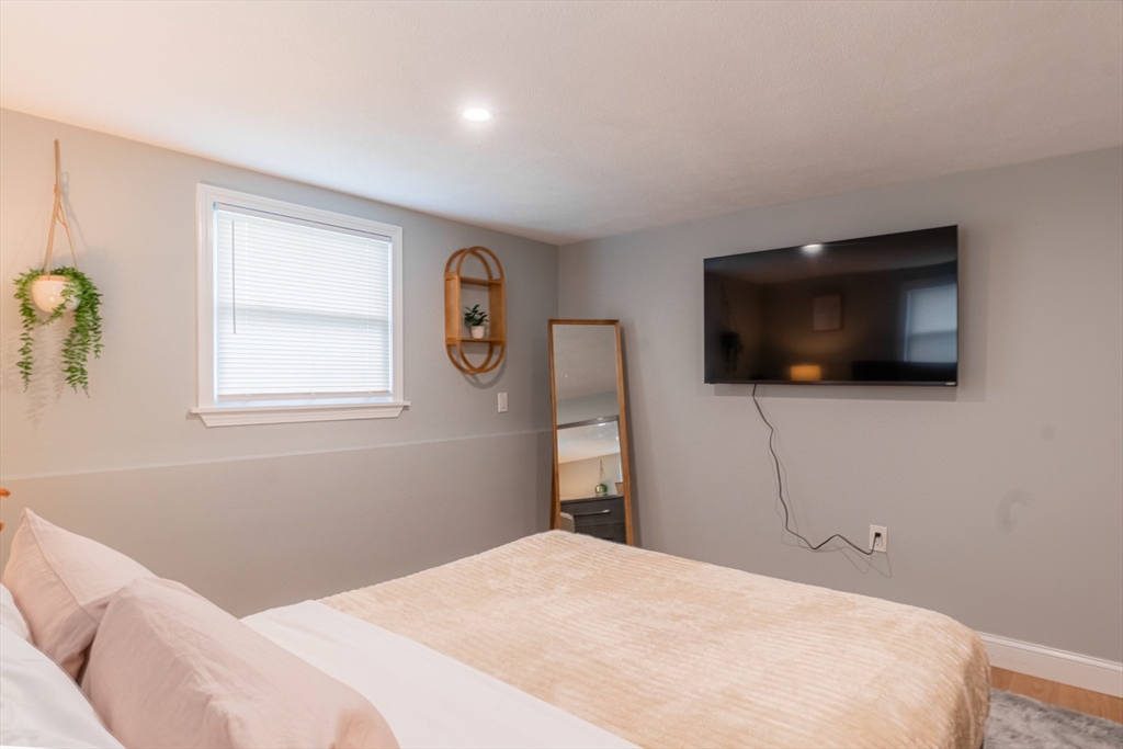 33 Bristow Street, Unit 2 Saugus, MA 01906 - Photo 10 of 21 a bedroom with a bed and a flat screen tv