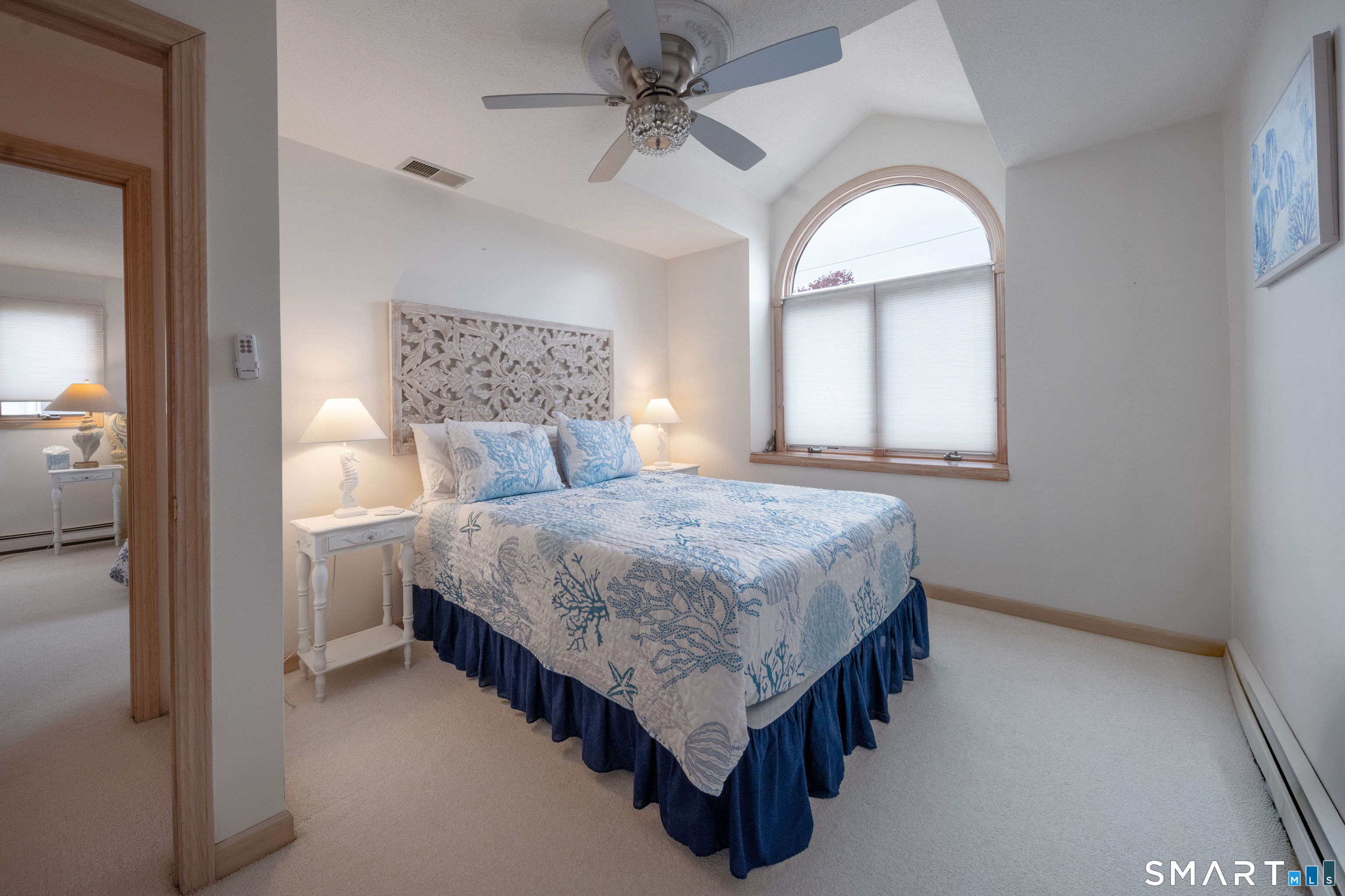 5 A Loop Road, Unit 5A Clinton, CT 06413 - Photo 20 of 37 a bedroom with a bed chandelier and a window