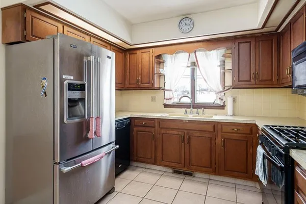 a kitchen with stainless steel appliances granite countertop a refrigerator and a sink