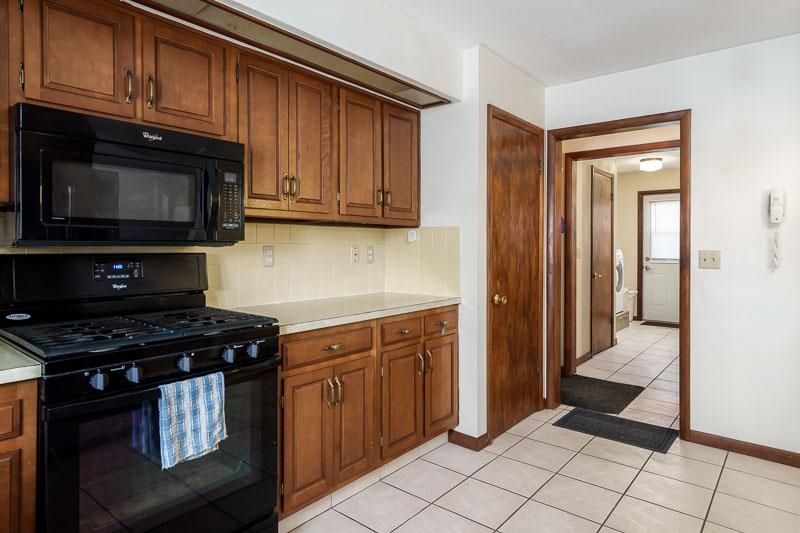 1126 Main Street Pecatonica, IL 61063 - Photo 12 of 40 a kitchen with granite countertop a stove and a microwave