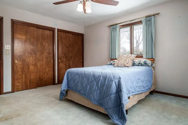 a bedroom with a bed and a window