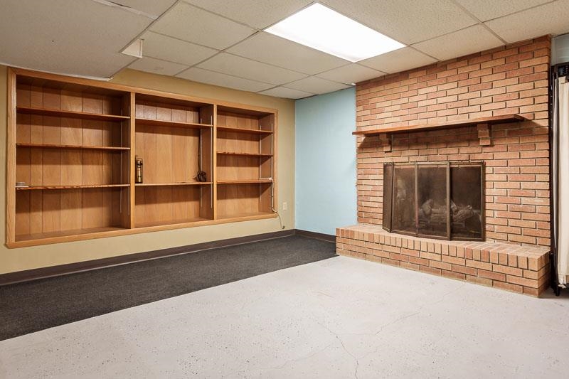1126 Main Street Pecatonica, IL 61063 - Photo 24 of 40 a view of an empty room with a fireplace and a window