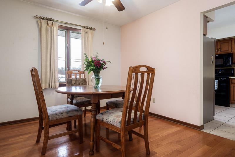 1126 Main Street Pecatonica, IL 61063 - Photo 7 of 40 a view of a dining room with furniture and wooden floor