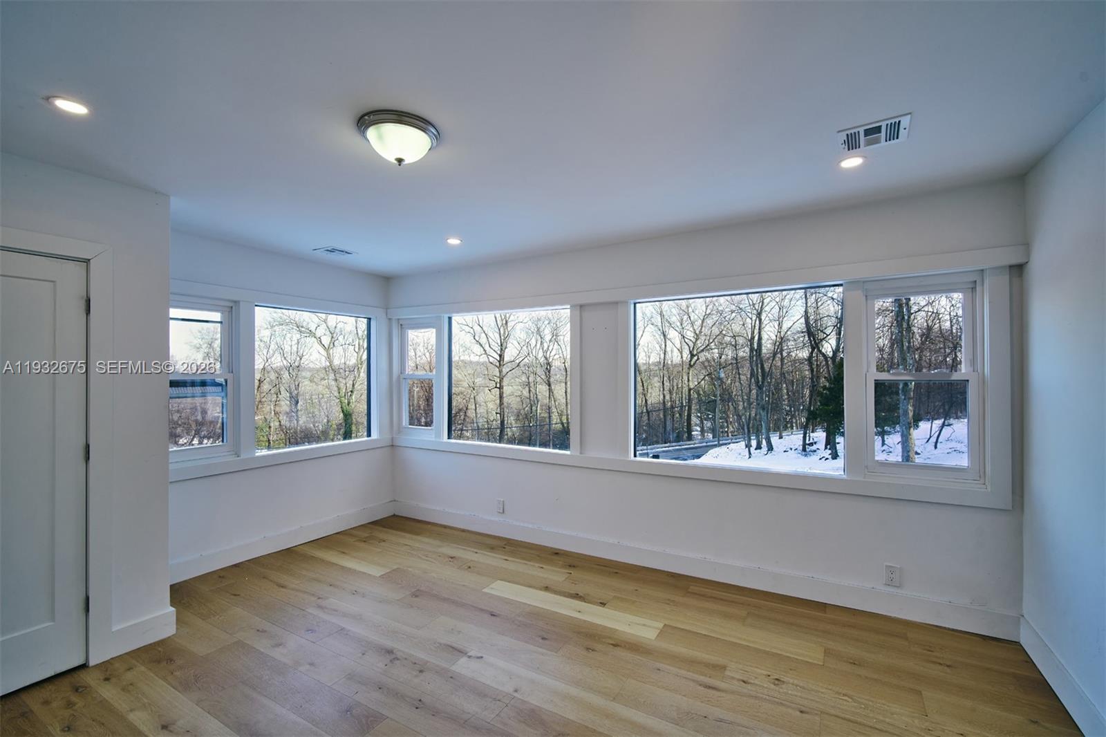 189 McNamara Road Spring Valley, NY 10977 - Photo 12 of 47 a view of an empty room with wooden floor and a window