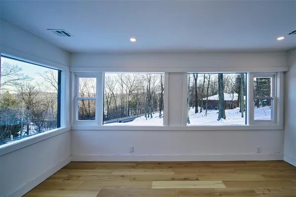 a view of an empty room with a fireplace