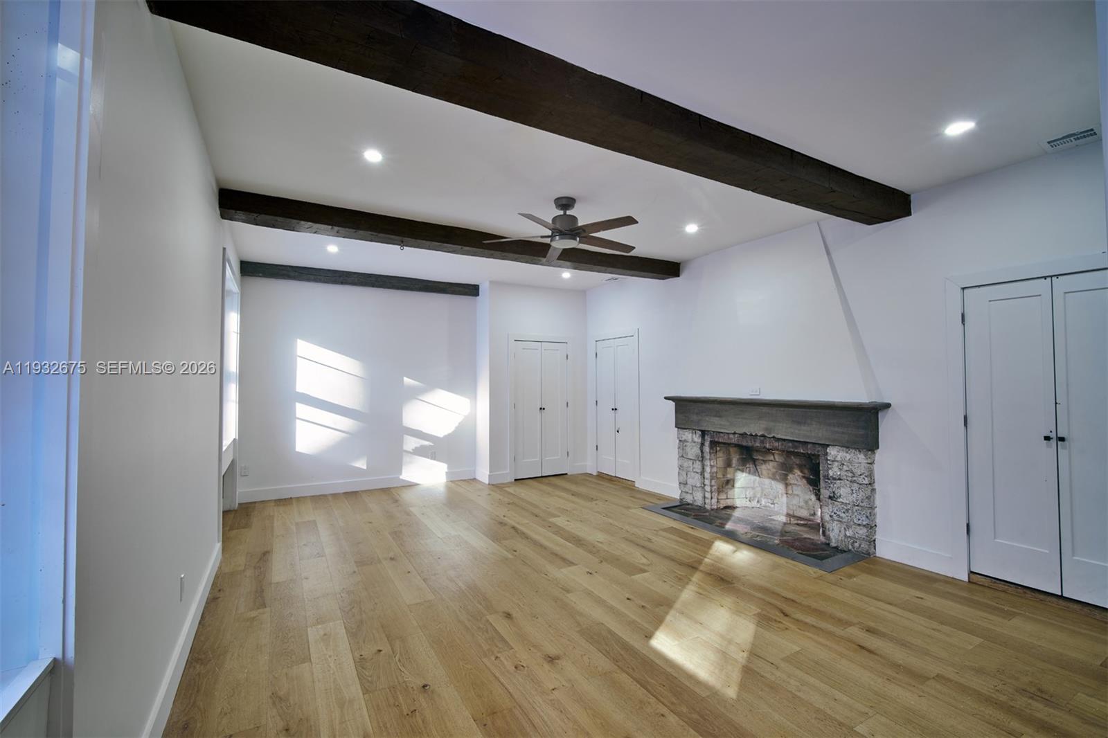 189 McNamara Road Spring Valley, NY 10977 - Photo 17 of 47 a view of empty room with wooden floor and fireplace