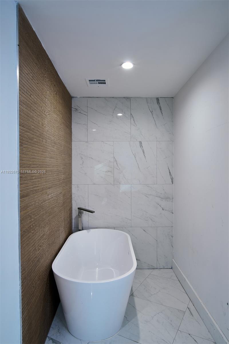 189 McNamara Road Spring Valley, NY 10977 - Photo 19 of 47 a white bath tub sitting in a bathroom
