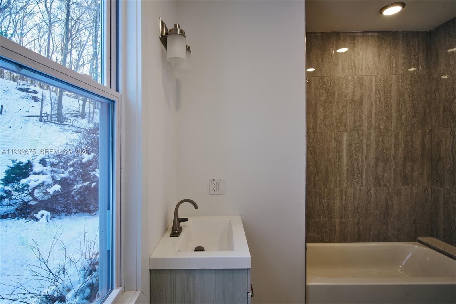 189 McNamara Road Spring Valley, NY 10977 - Photo 22 of 47 a bathroom with a sink and shower
