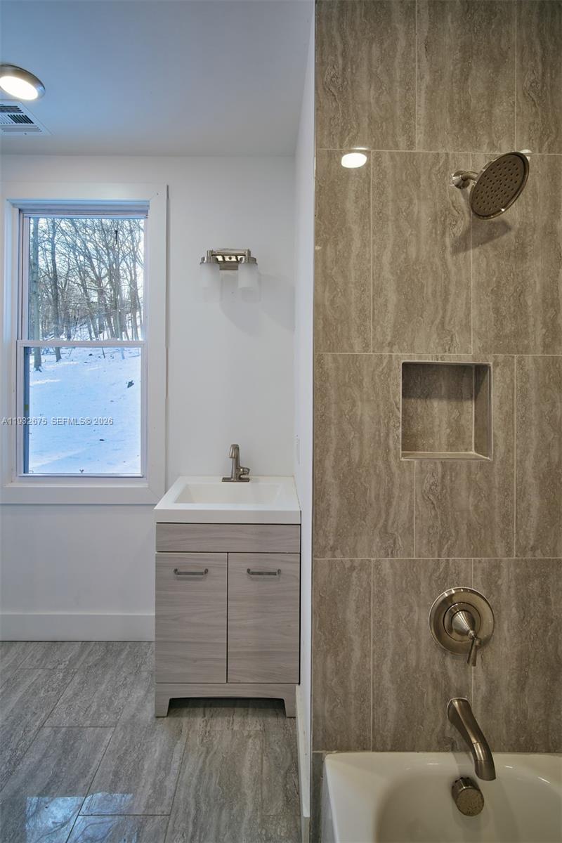 189 McNamara Road Spring Valley, NY 10977 - Photo 23 of 47 a bathroom with a sink and a window