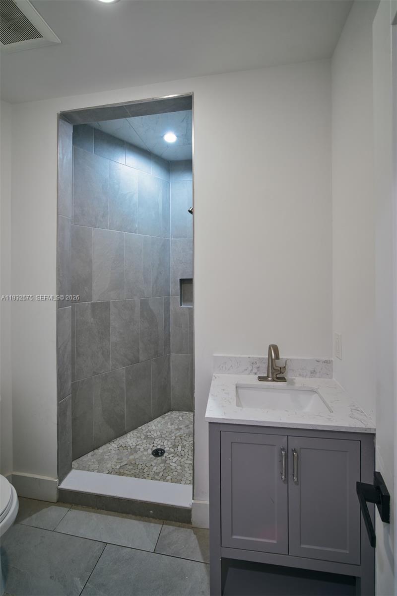 189 McNamara Road Spring Valley, NY 10977 - Photo 28 of 47 a bathroom with a sink a toilet and shower