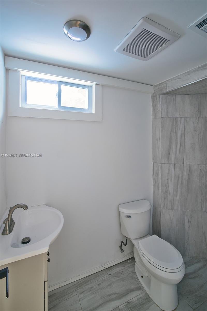 189 McNamara Road Spring Valley, NY 10977 - Photo 31 of 47 a bathroom with a toilet sink and mirror