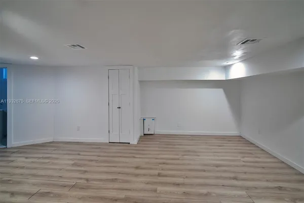a room with furniture a table and a projector screen