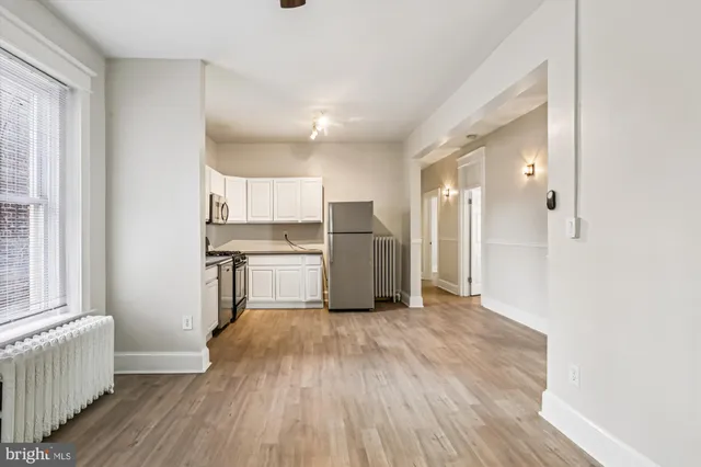 a view of a kitchen with wooden floor