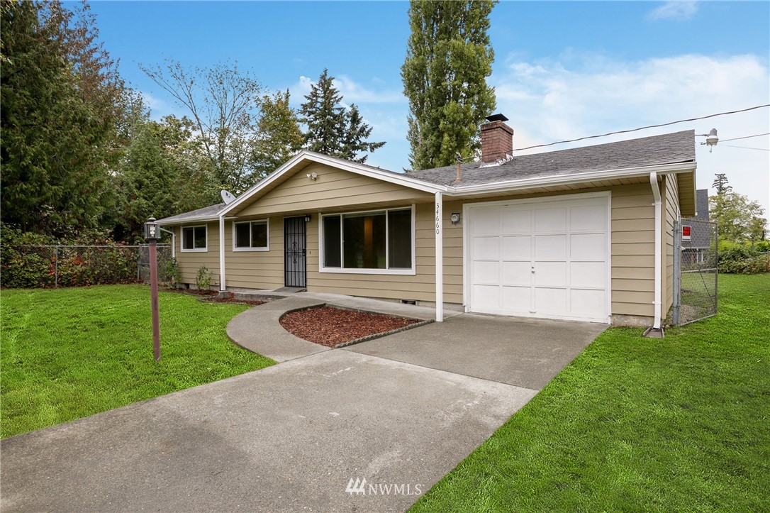 34660 Military Road South Federal Way, WA 98001 - Photo 2 of 24 a front view of a house with a yard and garage