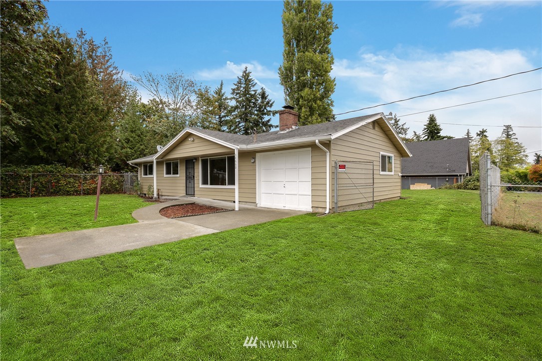 34660 Military Road South Federal Way, WA 98001 - Photo 12 of 24 a view of a yard in front of a house with large windows