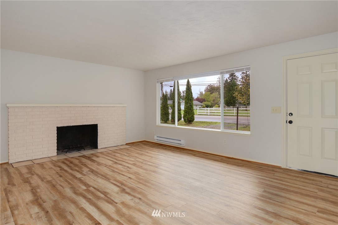34660 Military Road South Federal Way, WA 98001 - Photo 3 of 24 a view of empty room with wooden floor and fireplace