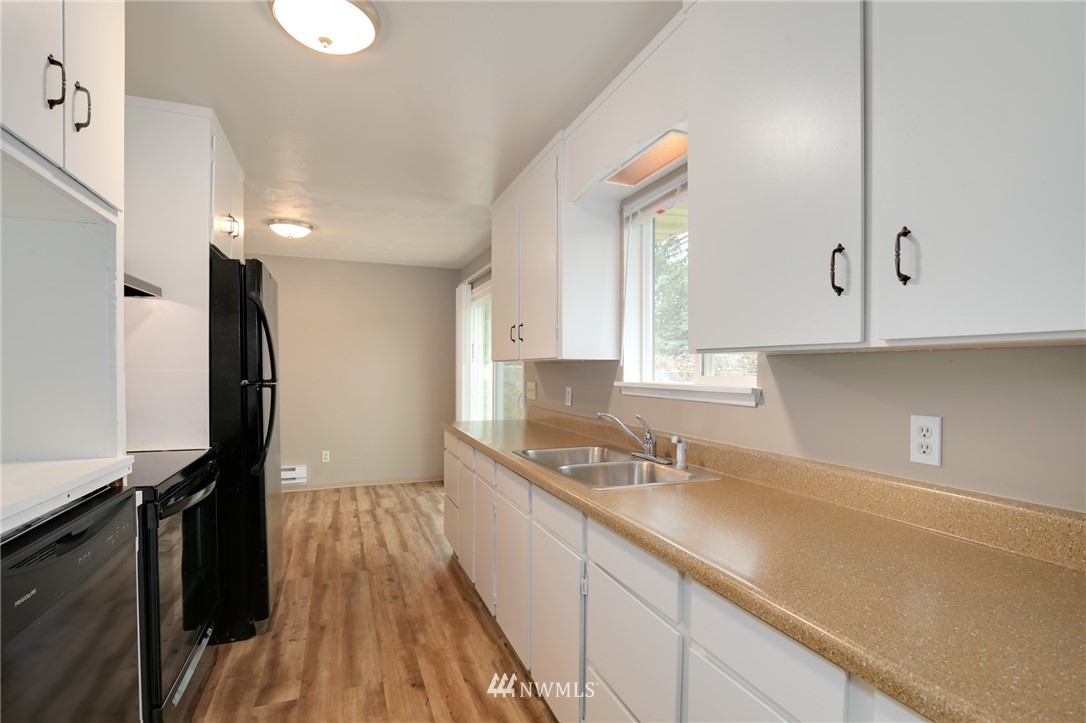34660 Military Road South Federal Way, WA 98001 - Photo 10 of 24 a kitchen with granite countertop a sink a stove and cabinets
