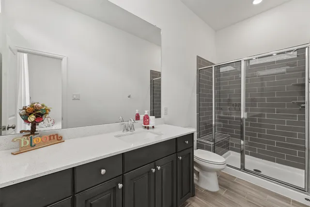 a bathroom with a sink toilet and shower