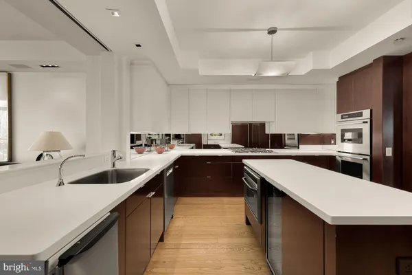 a kitchen with stainless steel appliances kitchen island granite countertop a stove a sink and a microwave