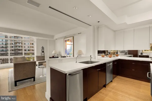 a kitchen with stainless steel appliances kitchen island granite countertop a stove and a refrigerator