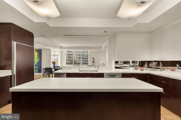 a kitchen with stainless steel appliances a refrigerator and a table