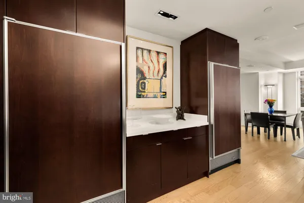 a living room with furniture and a dining table with kitchen view