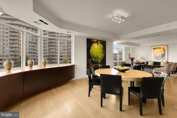 a living room with furniture a fireplace and a floor to ceiling window
