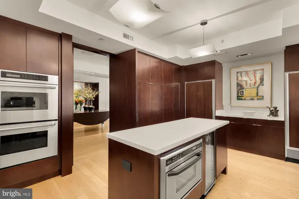 a kitchen with a sink stainless steel appliances and white cabinets