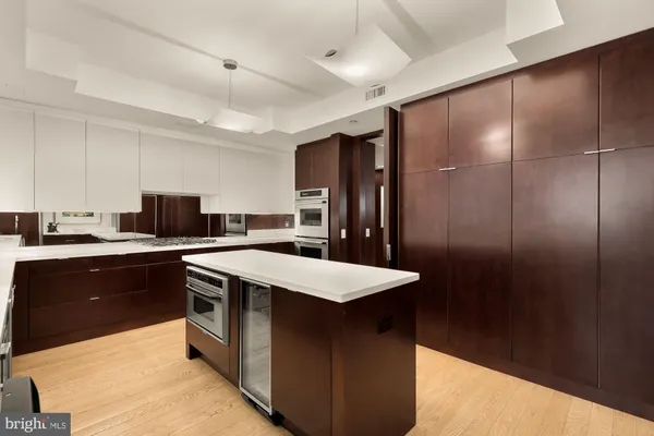 a kitchen with a sink a stove a counter space and cabinets