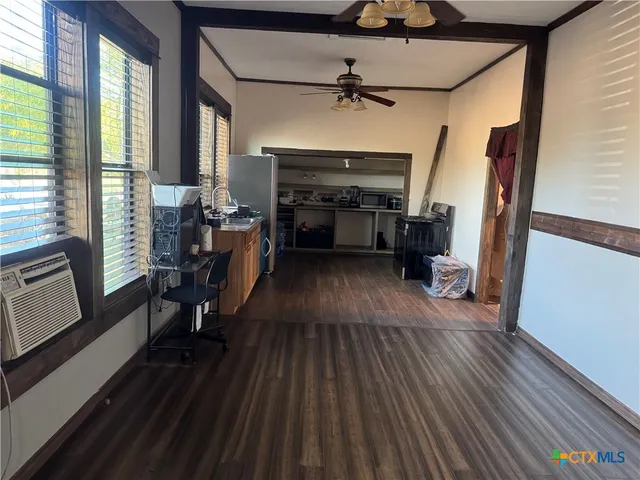 a view of a livingroom with furniture and hardwood floor