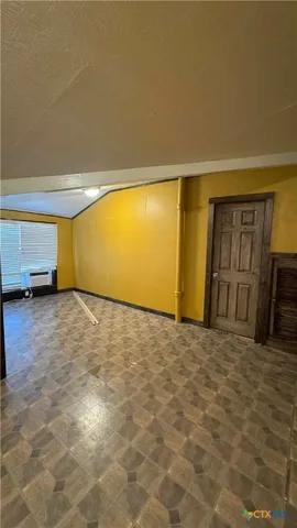 a view of a living room hardwood floor and a ceiling fan
