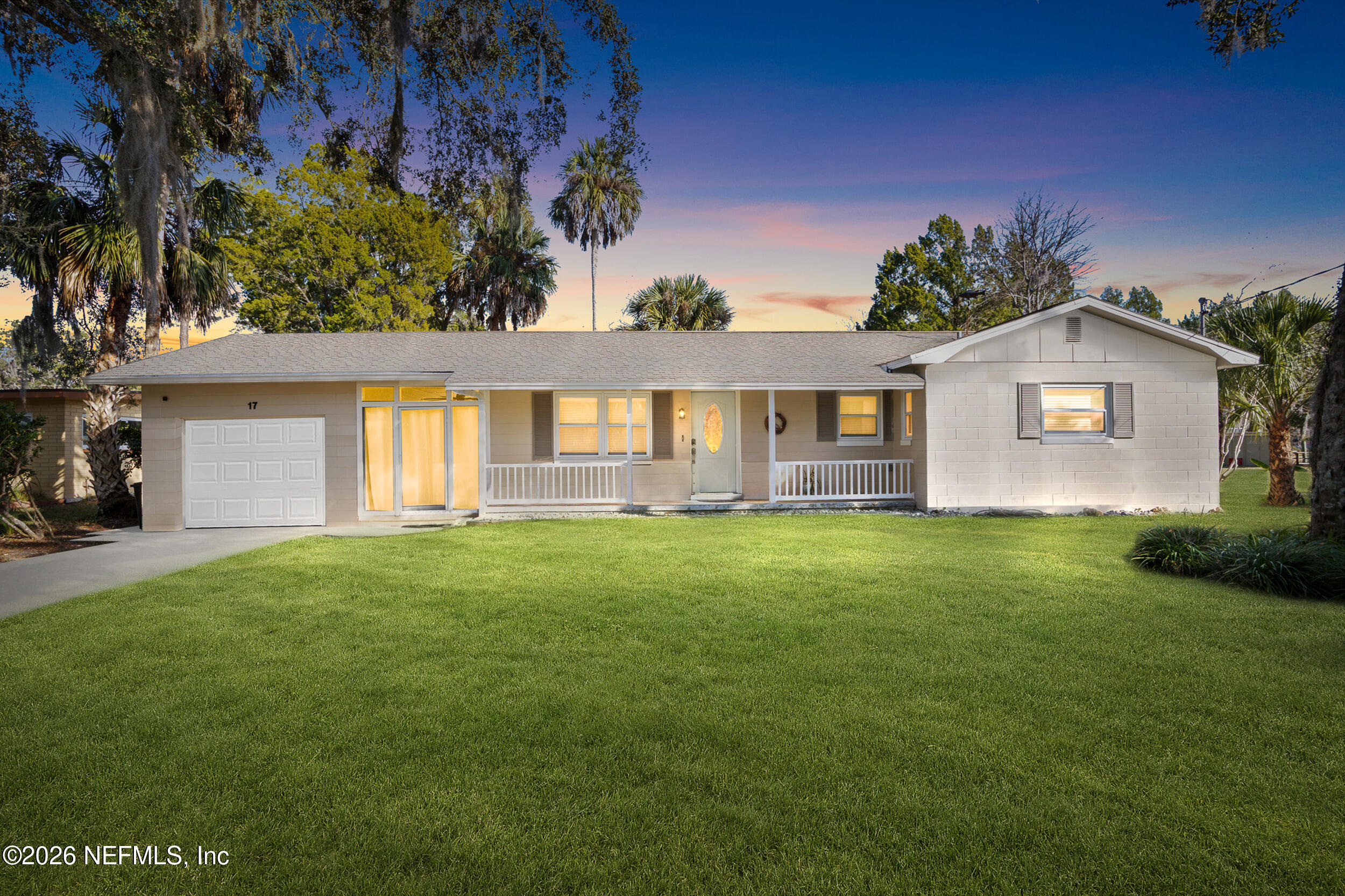 17 Palm Drive Yankeetown, FL 34498 - Photo 1 of 45 a front view of a house with a garden
