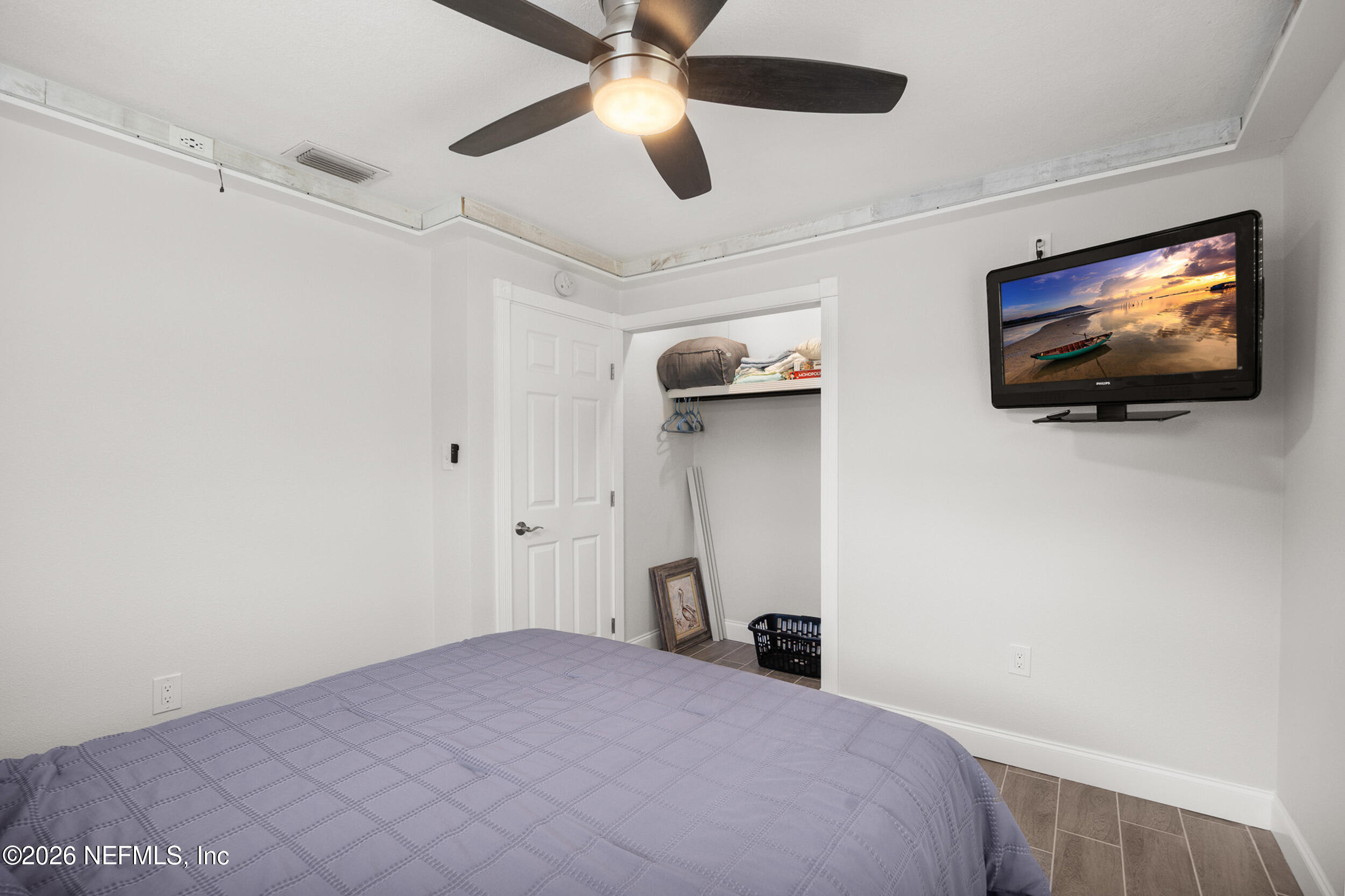 17 Palm Drive Yankeetown, FL 34498 - Photo 18 of 45 a bedroom with a bed and a flat screen tv