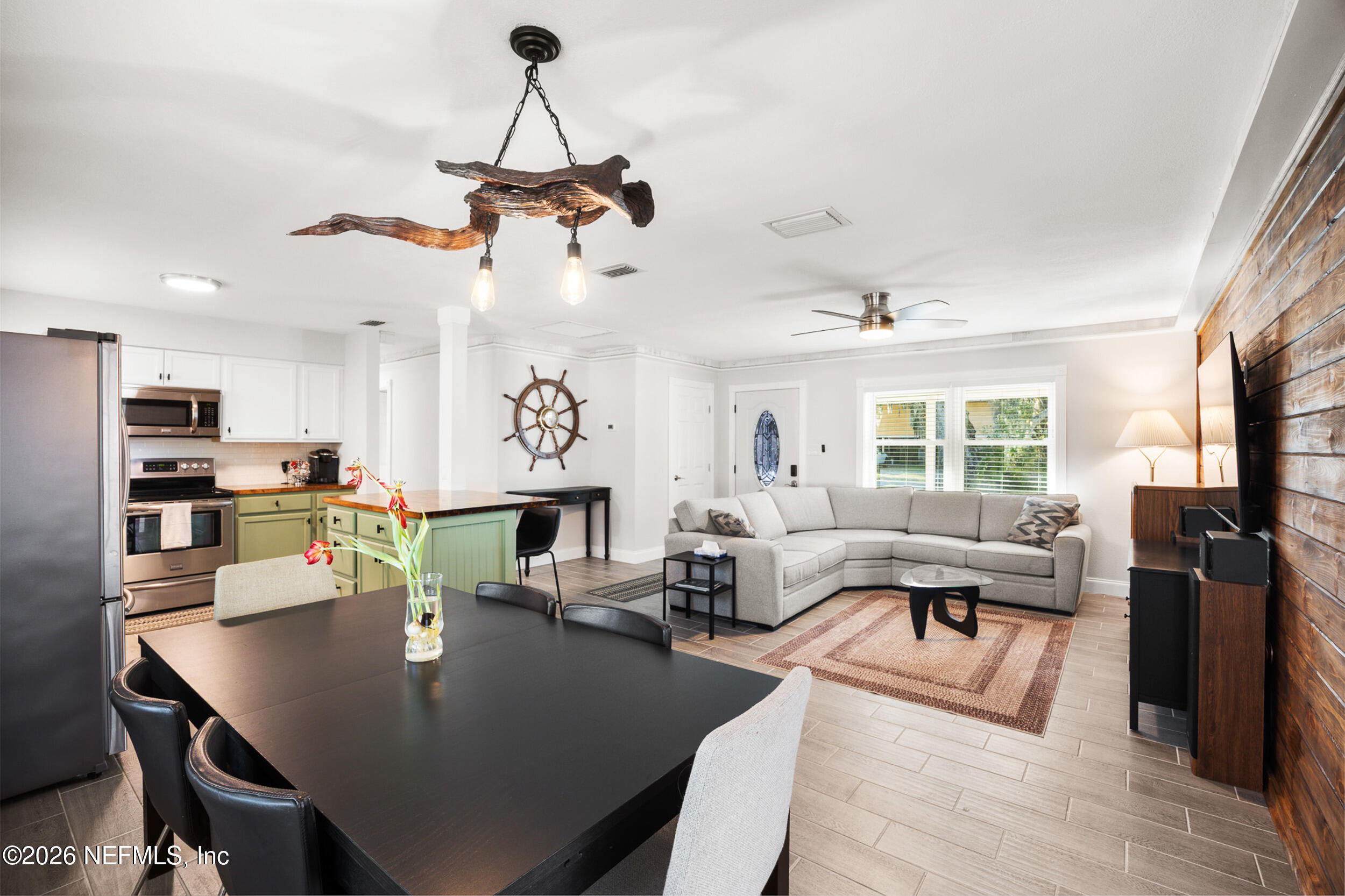 17 Palm Drive Yankeetown, FL 34498 - Photo 3 of 45 a living room with furniture kitchen view and a chandelier