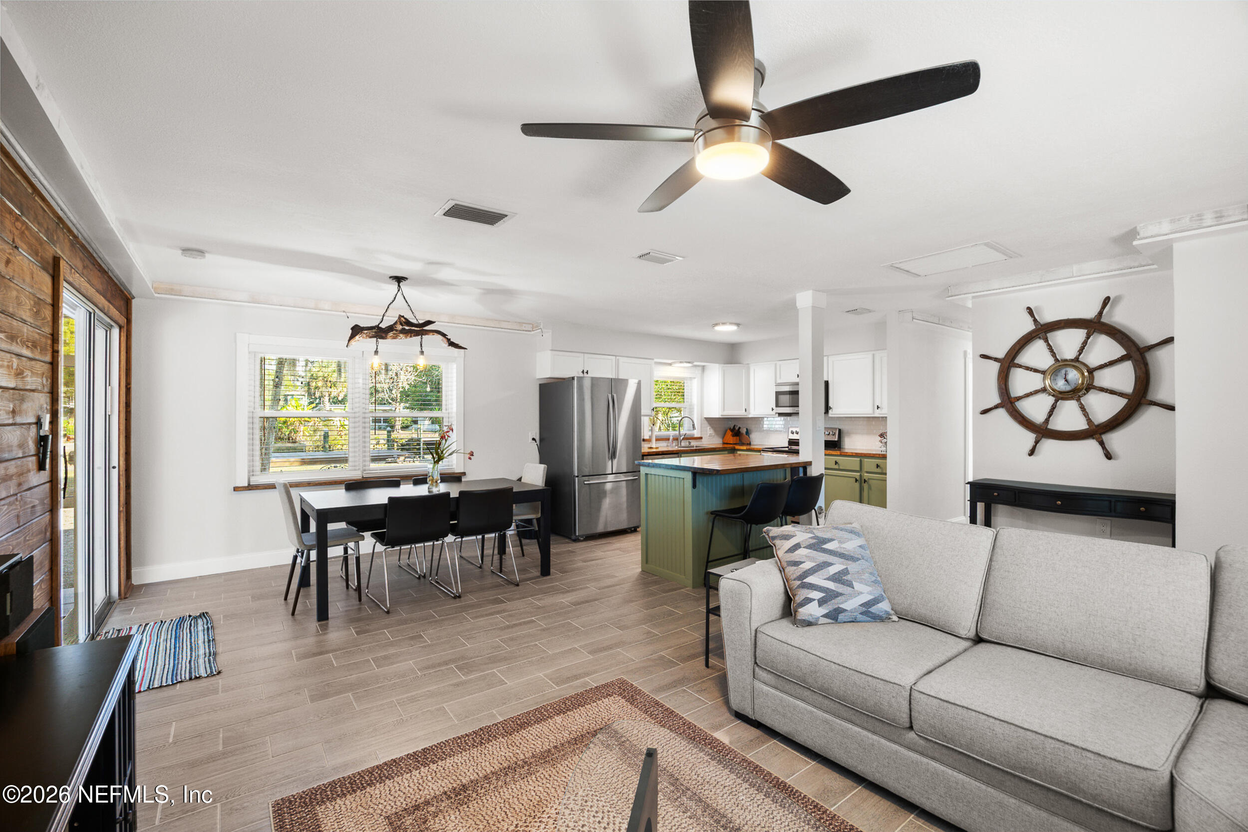17 Palm Drive Yankeetown, FL 34498 - Photo 9 of 45 a living room with furniture kitchen view and a large window