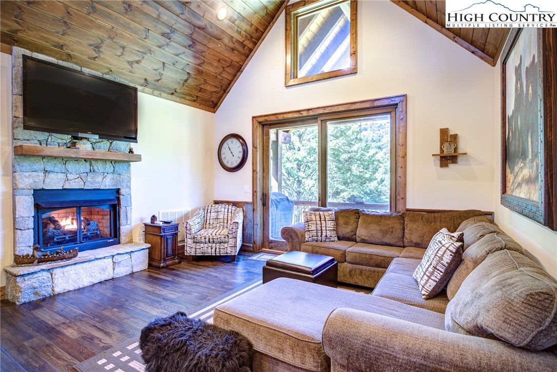 242 Camp Eagle Loop Banner Elk, NC 28604 - Photo 11 of 25 a living room with furniture a flat screen tv and a fireplace
