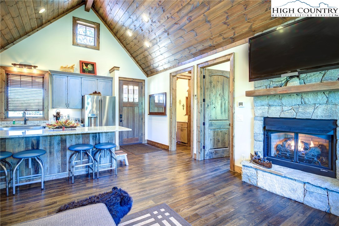 242 Camp Eagle Loop Banner Elk, NC 28604 - Photo 13 of 25 a living room with furniture a flat screen tv and a fireplace