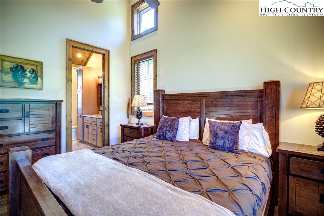 242 Camp Eagle Loop Banner Elk, NC 28604 - Photo 16 of 25 a bedroom with a large bed and a flat tv screen