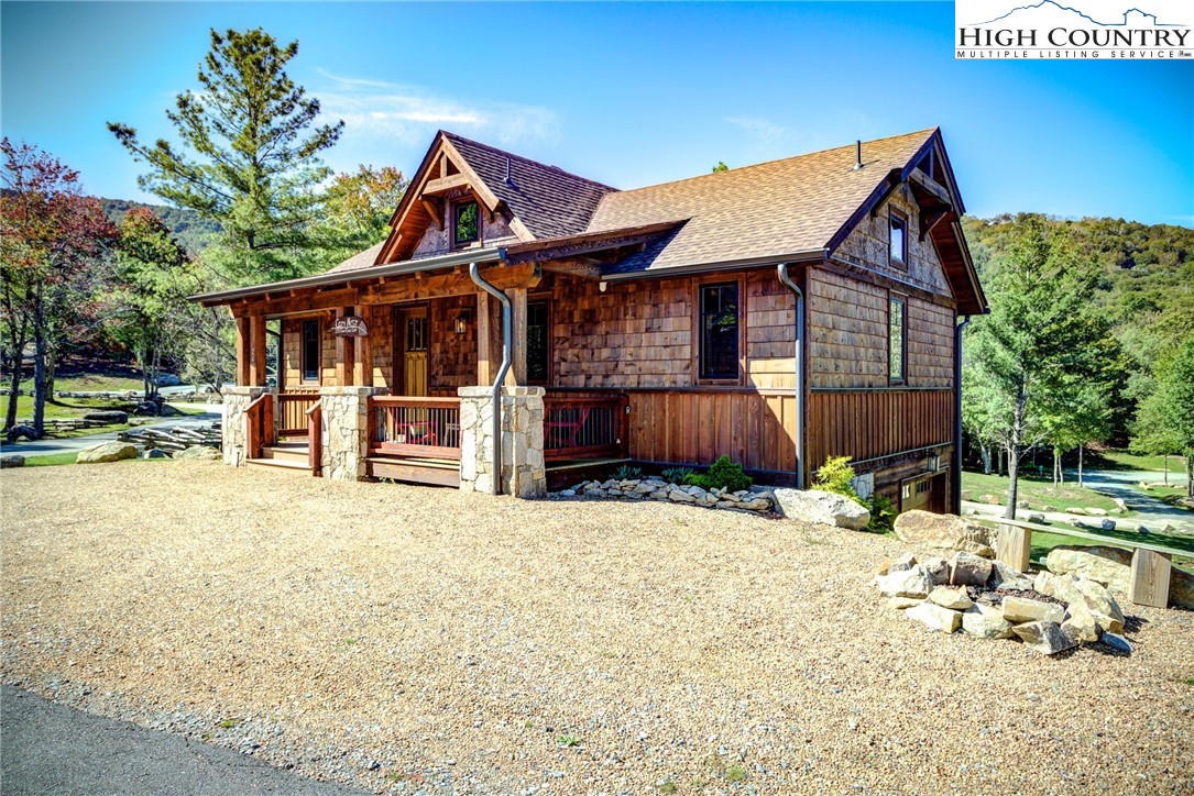 242 Camp Eagle Loop Banner Elk, NC 28604 - Photo 2 of 25 a view of a house with a yard and sitting area